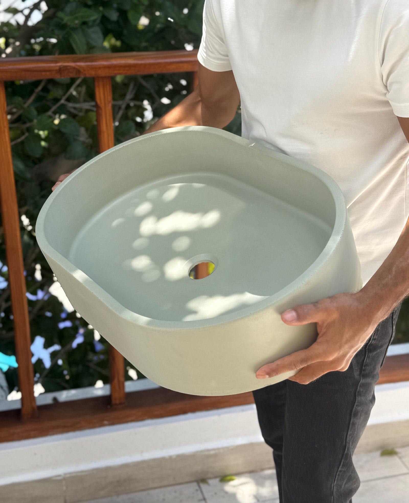 Rafael Soriano holding a handcrafted concrete basin